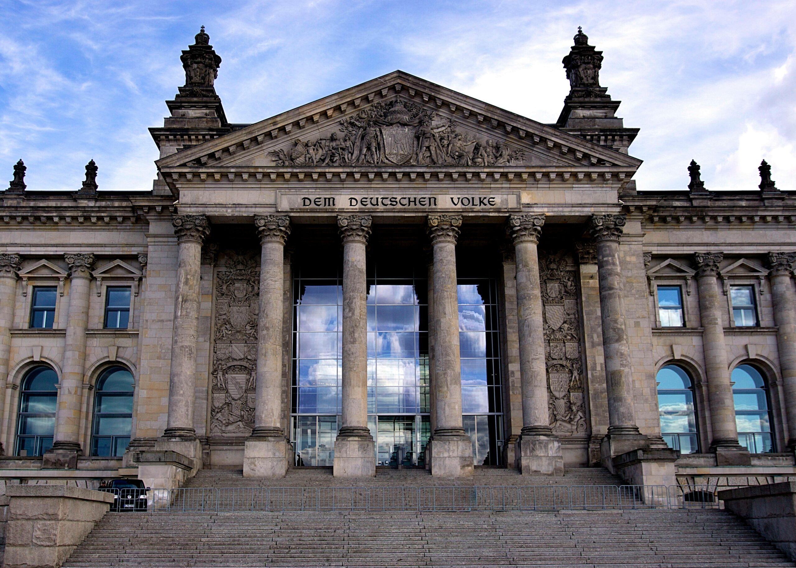 Historic Reichstag building facade with columns and steps in Berlin, Germany.